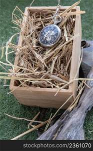A retro pocket watch on straw background in wooden box. gift to the beautiful memories of the two of us, Selective focus.