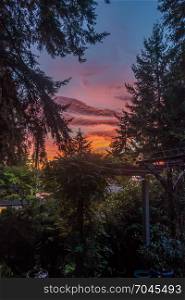 A rich sunset seen from the font porch of a house in Burien, Washington.
