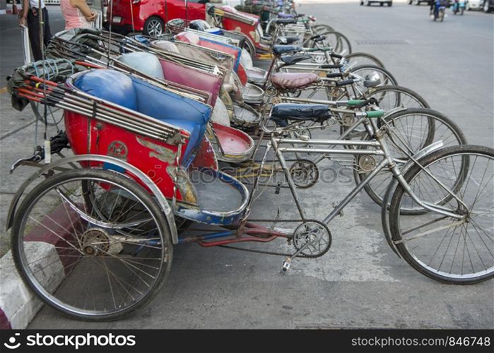 a riksha or bicycle taxi at a road in the city of Phitsanulok in the north of Thailand. Thailand, Phitsanulok, November, 2018.. THAILAND PHITSANULOK CITY ROAD BICYCLE TAXI