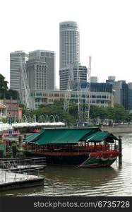 A river scene, with skyscrapers in the background, captured at Clarke Quay, Singapore