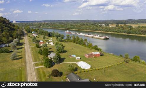 A river Tugboat pushes barge contents down the Ohi River south of Henderson West Virginia