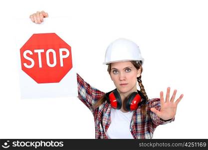 A road worker holding a stop sign.