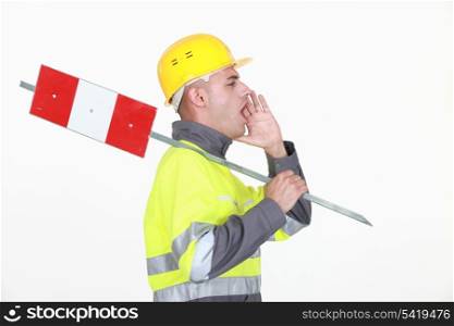 A road worker shouting instructions.