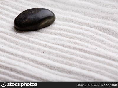 A rock in beautifully styled white sand