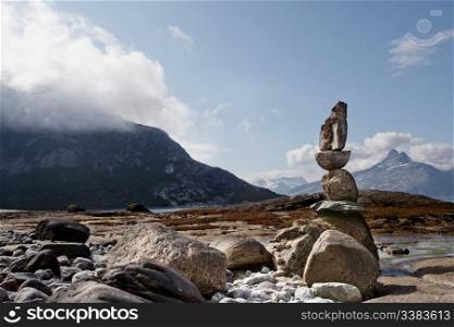 A rock sculpture statue on a Norwegian landscape