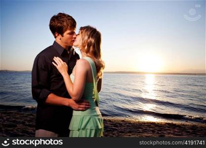 A romantic caucasian couple in love kissing on the beach
