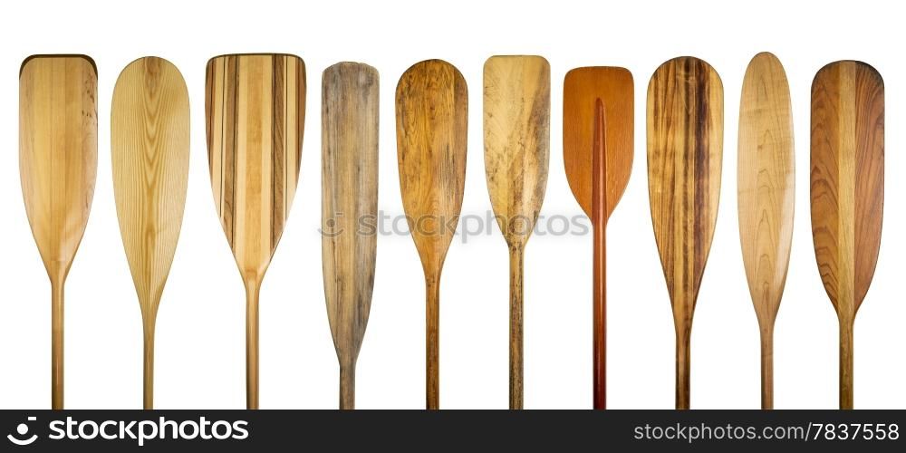 a row of 10 wooden canoe paddles, a variety of styles and shapes - paddling concept