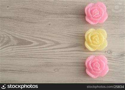 A row of candles in the shape of roses