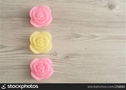 A row of candles in the shape of roses