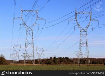 A row of electricity pylons in a field for a nuclear power