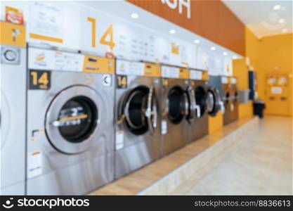 A row of qualified coin-operated washing machines in a public store. Concept of a self service commercial laundry and drying machine in a public room.. A row of qualified coin-operated washing machines in a public store.