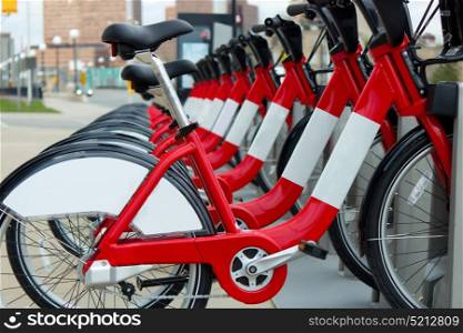 A row of red rental bicycles.