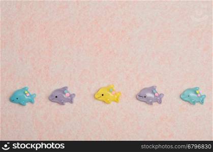 A row of small dolphins figures that is used for decorating