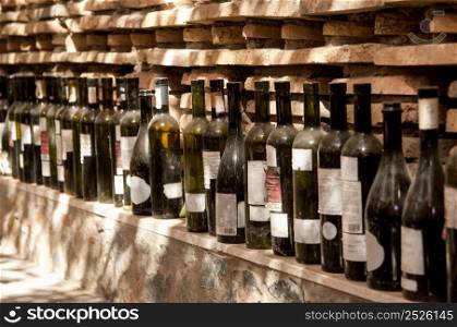a row of wine bottles on a brick wall background. row of old empty wine bottles. a row of wine bottles