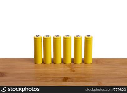 a row of yellow batteries on a white background