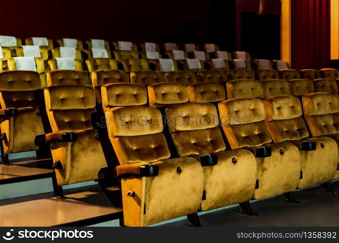 A row of yellow seat with popcorn on chair in the movie theater