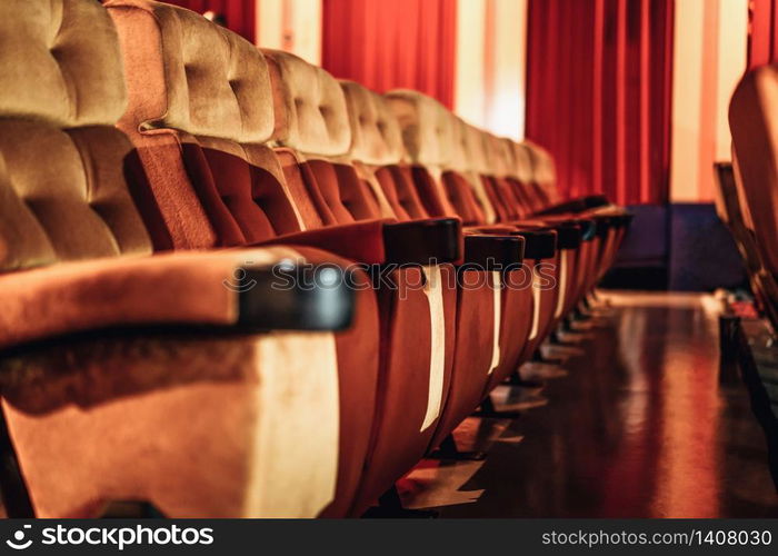 A row of yellow seat with popcorn on chair in the movie theater