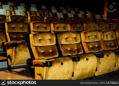 A row of yellow seat with popcorn on chair in the movie theater