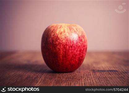 A royal gala apple on a wooden table