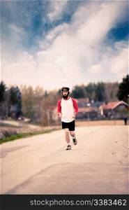 A runner with long hair and beard jogging in the country - Retro style image
