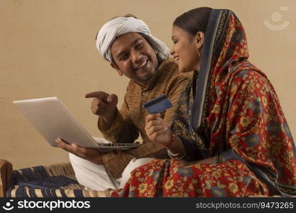 A RURAL COUPLE HAPPILY DOING ONLINE TRANSACTIONS TOGETHER