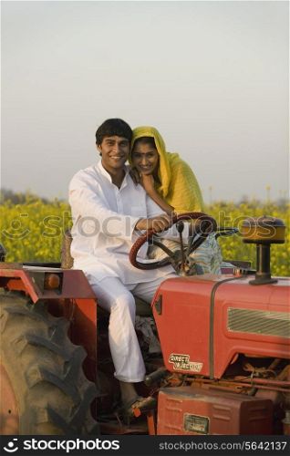 A rural couple on a tractor