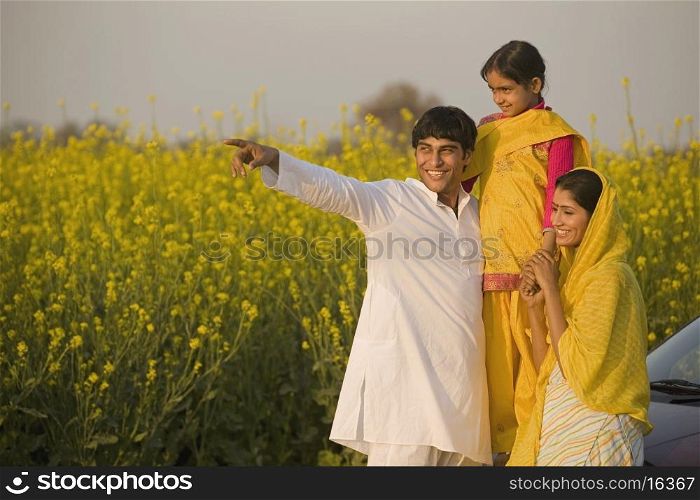 A rural family in front of their car