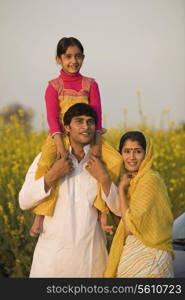 A rural family in front of their car