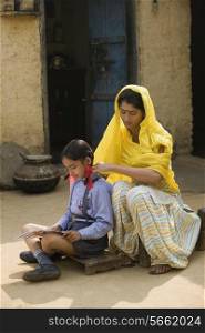 A rural mother sitting with her daughter