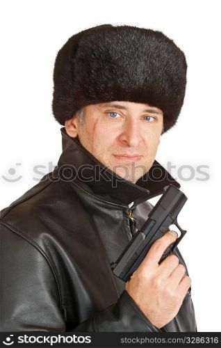 A russian mafia figure with a large facial scar carrying a hand gun