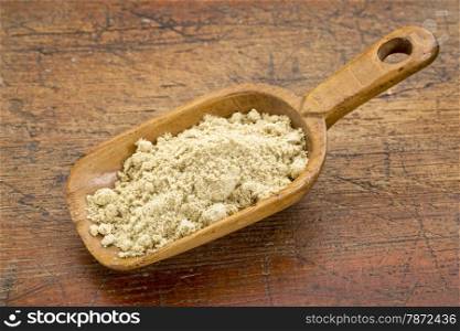 a rustic scoop of rice bran against grunge wood