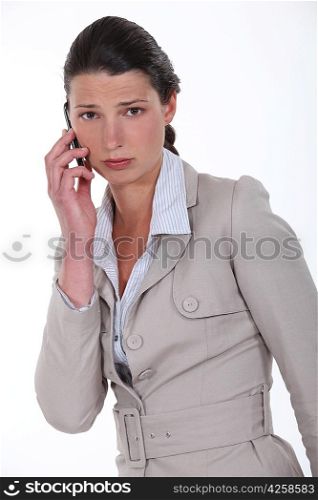 A sad businesswoman over the phone.
