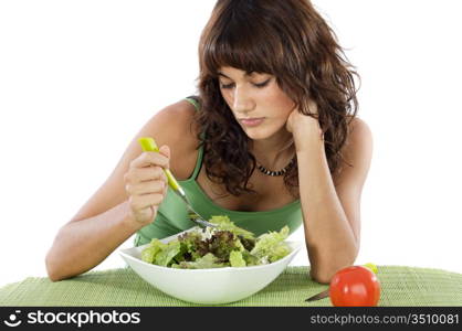 A sad teen eating salad. Care his diet.