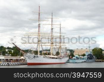 A sailboat near the pier in the seaport of Gdynia.. Gdynia. Sea port.