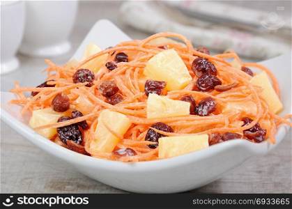 a salad of pineapple, fresh carrots, dried cranberries, yogurt dressed. Gluten free vegan .