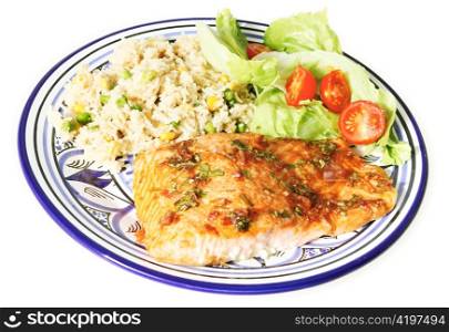 A Salmon fillet marinaded in a basil sauce and oven baked, served with vegetable rice and salad