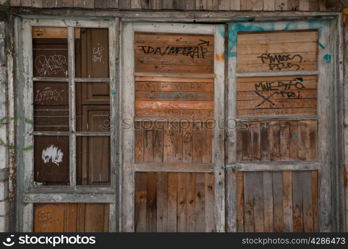 A sample of ubiquitous Greek grafitti on old wooden doorway.