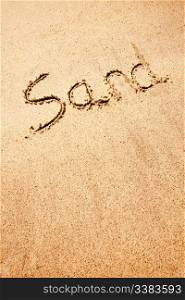 A sand background image with the word written with a stick