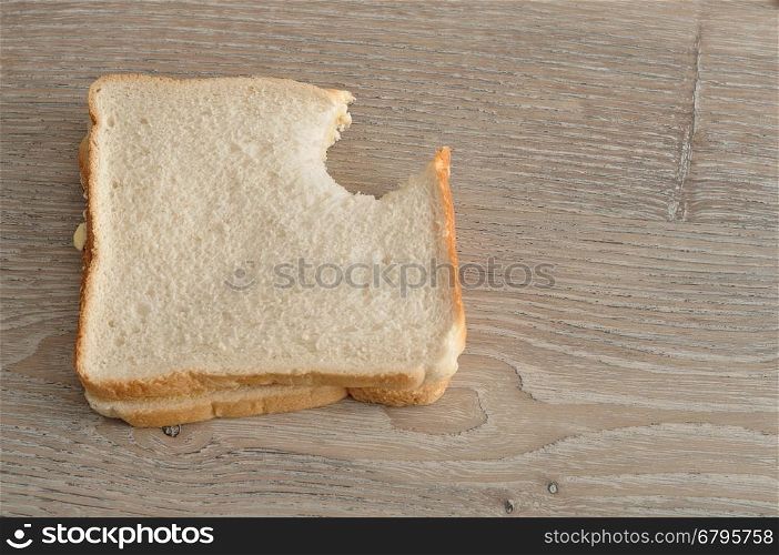 A sandwich with a bite taken out of it