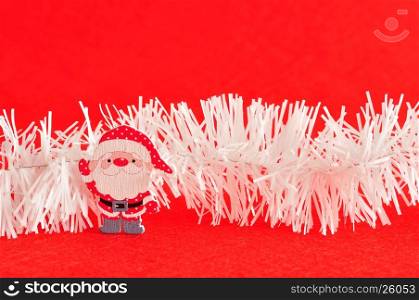 A santa with white tinsel isolated on a red background