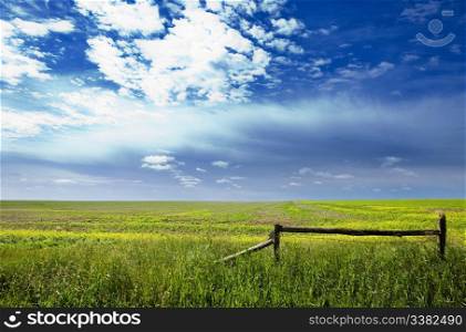 A saskatchewan prairie landscape with blue sky and field