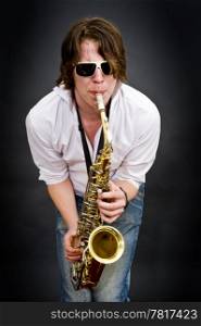 A saxophone player squeezing a high note from his instrument