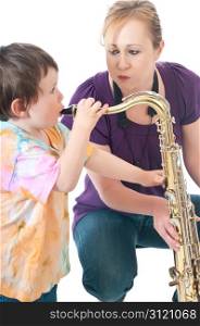 A saxophone playing young woman letting her son blow into the instrument.