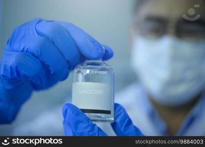 A scientist holding liquid chemical tube in laboratory, Science and technology healthcare concept. Scientist holding liquid chemical tube in laboratory, Science and technology healthcare concept