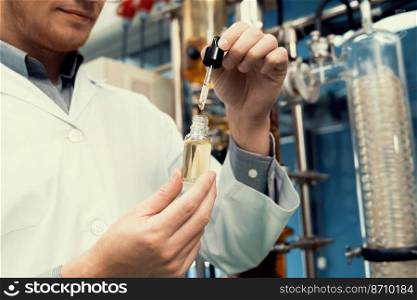 A scientist or apothecary extracts CBD hemp oil for medicinal purposes in a laboratory. Alternative cannabis-based medicine produced from cannabis extraction machine.. Scientist or apothecary extract CBD hemp oil for medicinal purpose in laboratory