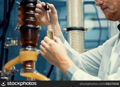 A scientist or apothecary extracts CBD hemp oil for medicinal purposes in a laboratory. Alternative cannabis-based medicine produced from cannabis extraction machine.. Scientist or apothecary extract CBD hemp oil for medicinal purpose in laboratory