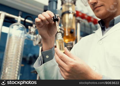 A scientist or apothecary extracts CBD hemp oil for medicinal purposes in a laboratory. Alternative cannabis-based medicine produced from cannabis extraction machine.. Scientist or apothecary extract CBD hemp oil for medicinal purpose in laboratory