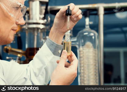 A scientist or apothecary extracts CBD hemp oil for medicinal purposes in a laboratory. Alternative cannabis-based medicine produced from cannabis extraction machine.. Scientist or apothecary extract CBD hemp oil for medicinal purpose in laboratory