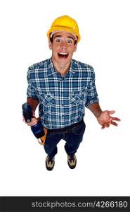 A screaming tradesman holding a power tool