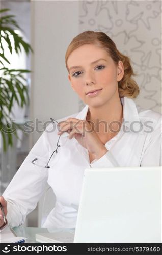 A secretary in front of her laptop